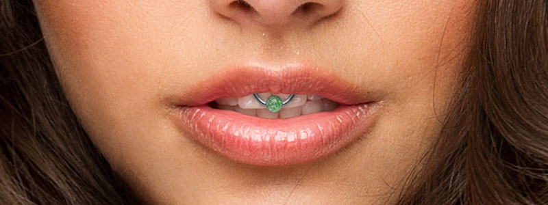 Lip Frenulum Piercing With Green Bead Ring