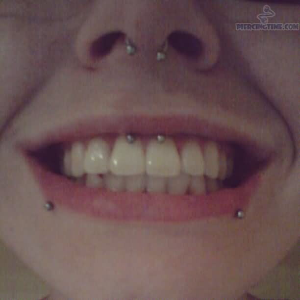 Lower Lip, Septum And Lip Frenulum Piercing With Circular Barbell