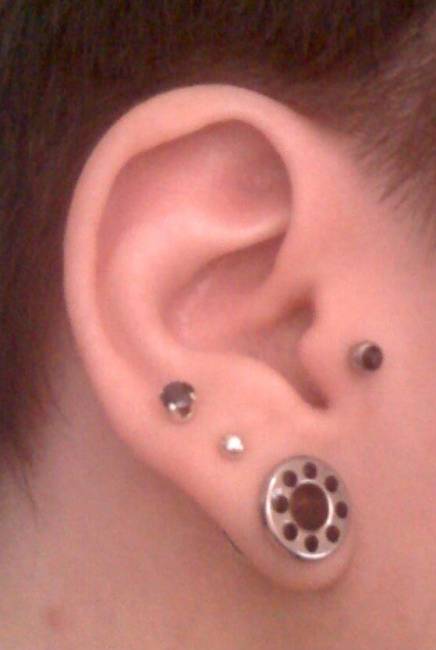 Right Ear Tragus And Stretched Lobe Piercing