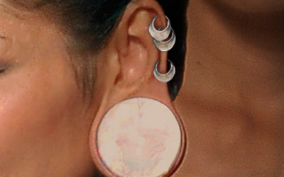 White Gauge Stretched Lobe Piercing On Left Ear