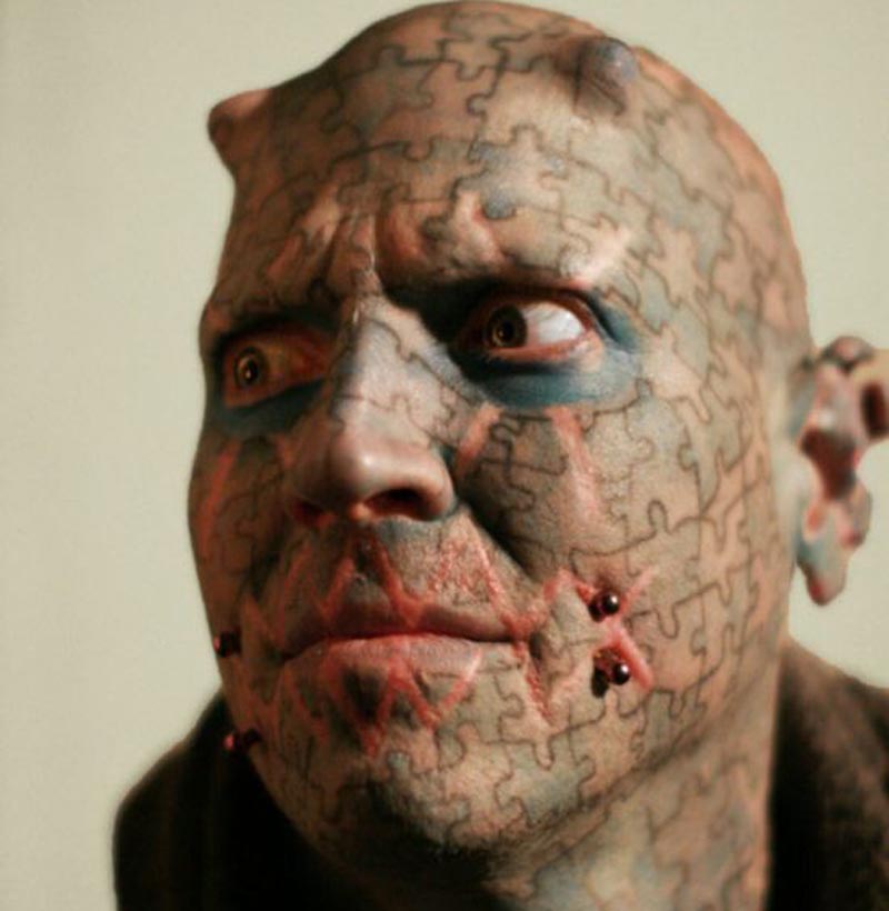 Extreme Puzzles Tattoo On Man Face