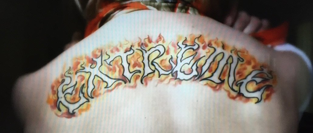 Flaming Extreme Word Tattoo On Upper Back