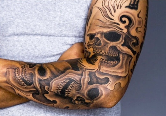 Grey Skulls Tattoos On Left Sleeve by Ami James