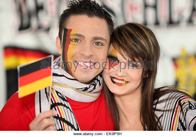 Couple With German Flag Paint On Face During German Unity Day Celebration