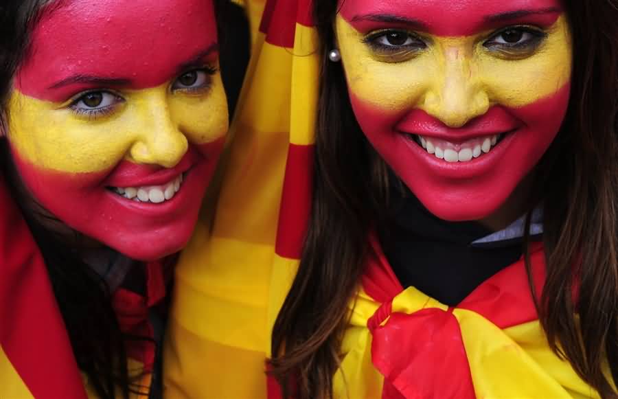 Girls Of Spain Painted Face As National Flag During National Day Of Spain Celebration