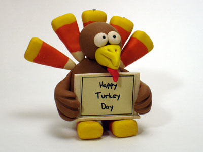 Turkey With Happy Turkey Day Signboard In Hand