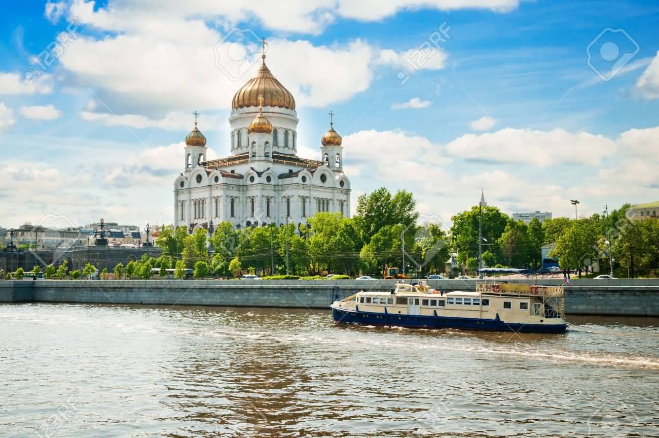 A Ferry In Moskva River Passing In Front Of The Cathedral Of Christ The Saviour