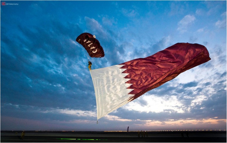 A Paraglider With A Qatar Flag During Qatar National Day