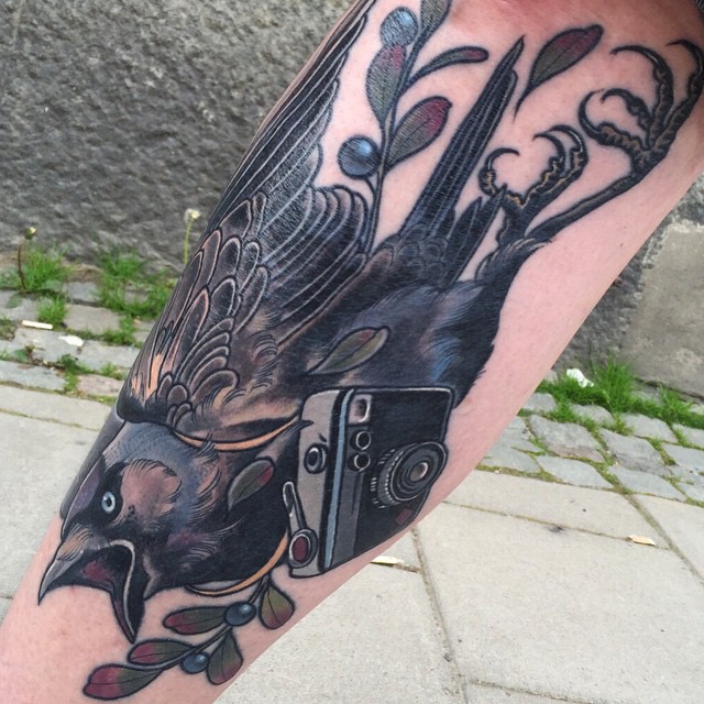 Camera And Flying Crow Tattoo On Leg