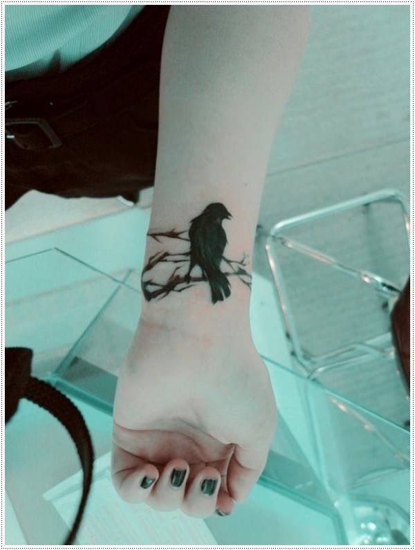 Girl With Crow Tattoo On Left Wrist