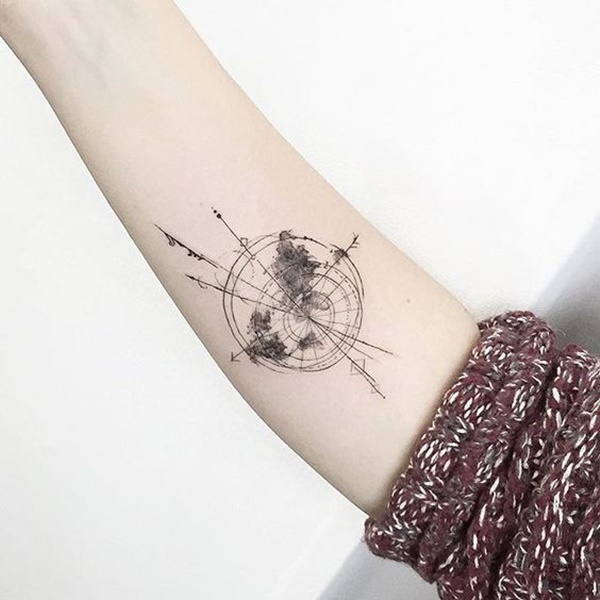 Black globe and compass tattoo with directions on right inner upper arm