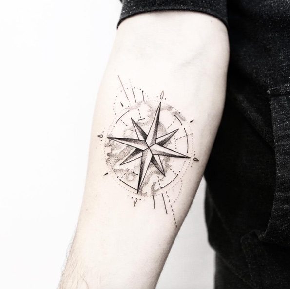 Black shaded globe and compass tattoo on inner mid arm