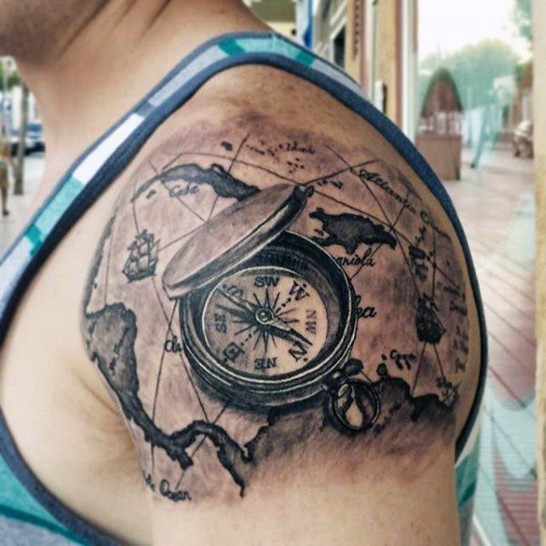 Black shaded globe and compass tattoo on left shoulder for men