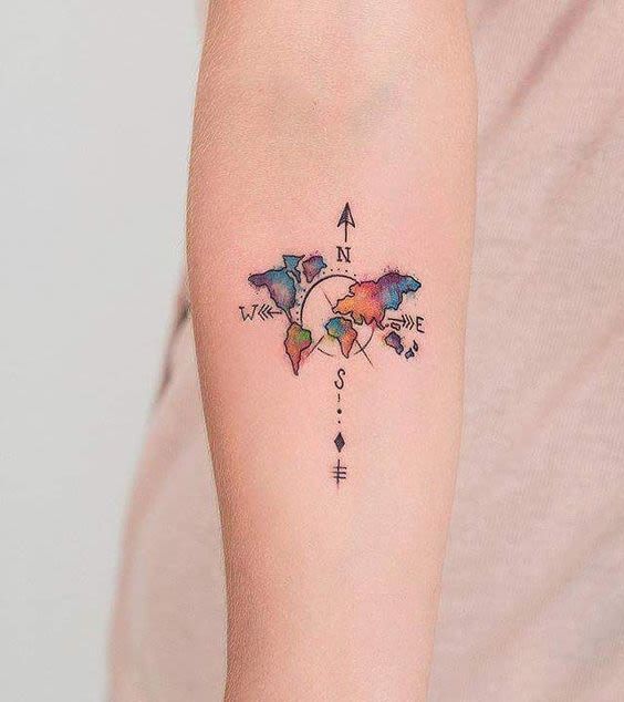 Colorful watercolor globe and compass tattoo with map on inner arm for women