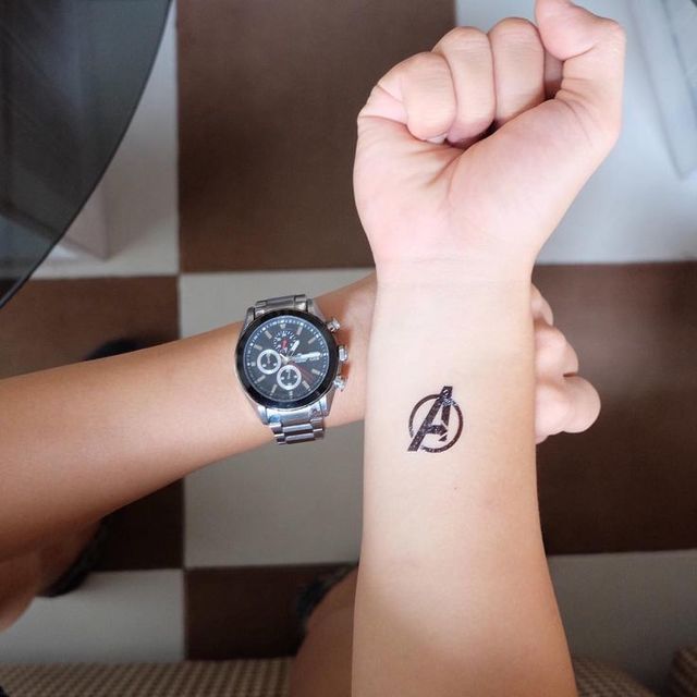 Black A logo avengers tattoo below inner right wrist