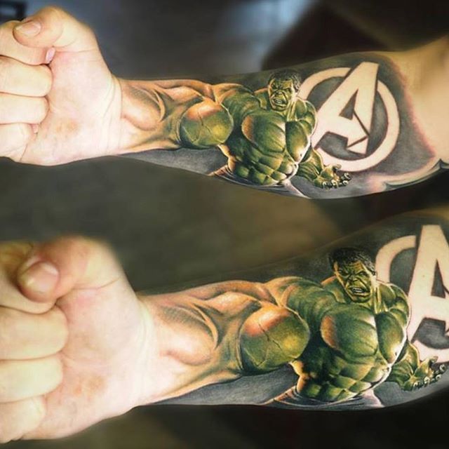 Green and black hulk with A logo avengers tattoo on inner forearm for men