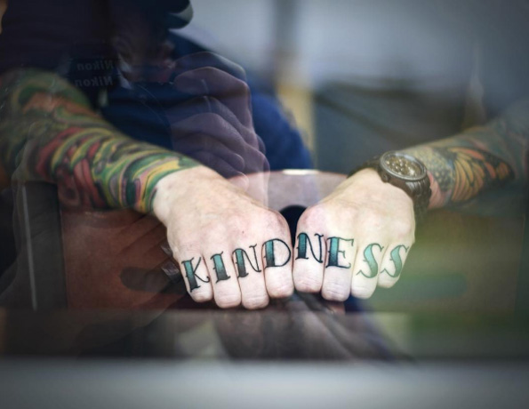 Black and blue kindness texted knuckle tattoo