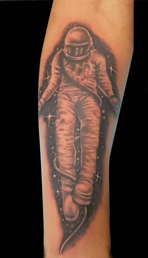 Black and grey shaded astronaut tattoo on inner forearm for men