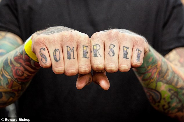 Black and yellow somerset texted knuckle tattoo