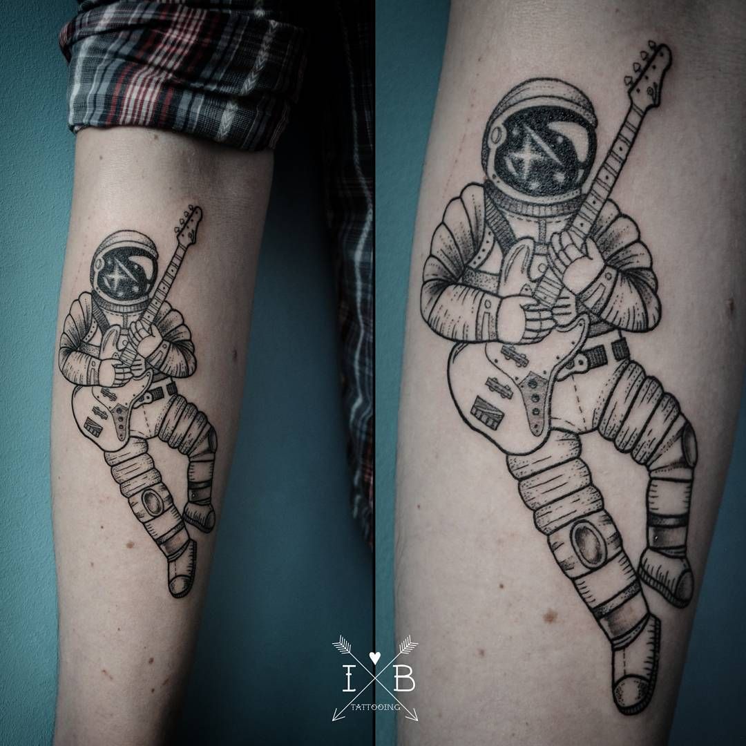 Black astronaut with guitar tattoo below knee