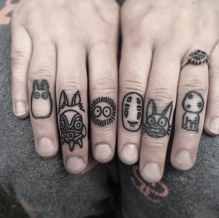 Black cartoon knuckle tattoo