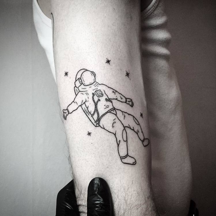 Black floating astronaut with stars tattoo on arm by Pokeeeeeeeoh