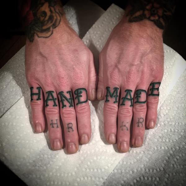 Black hand made wording knuckle tattoo