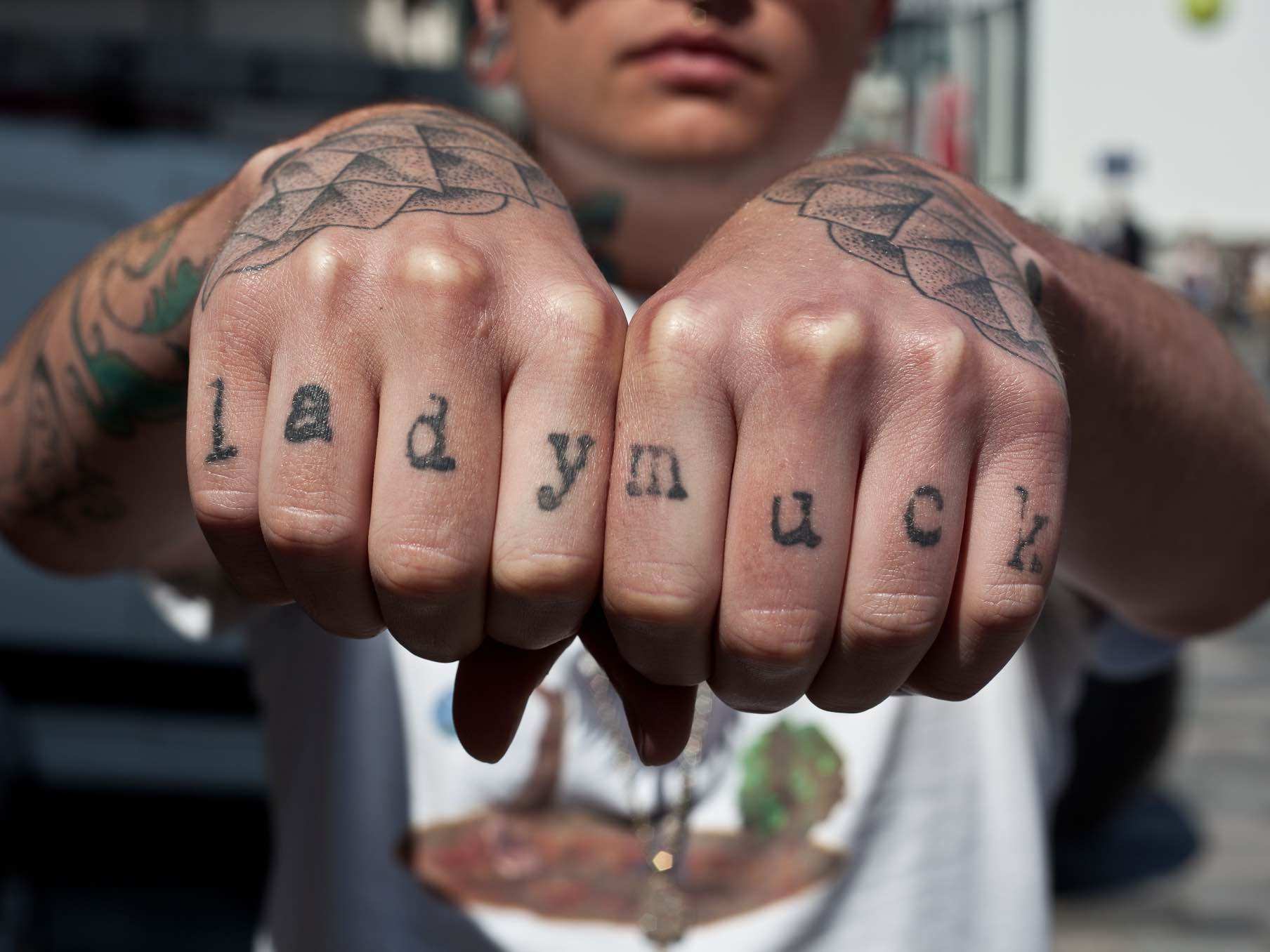 Black lady muck texted knuckle tattoo by Edward Bishop