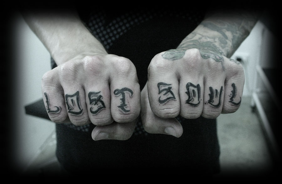 Black lost soul wording knuckle tattoo