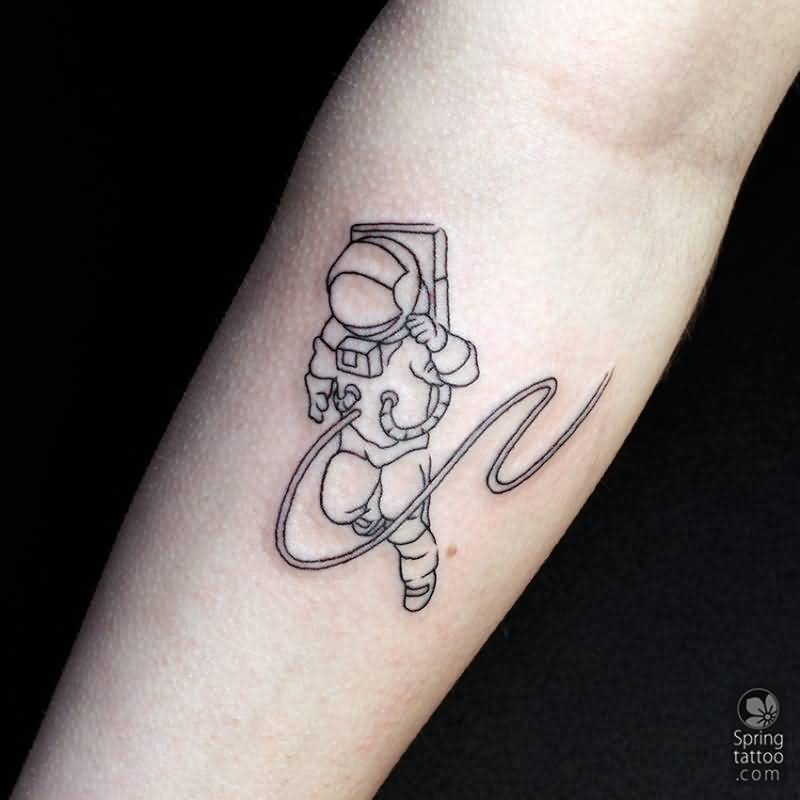 Black outlined astronaut tattoo on inner forearm