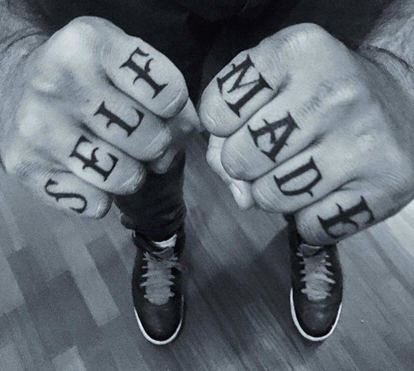 Black self made wording knuckle tattoo