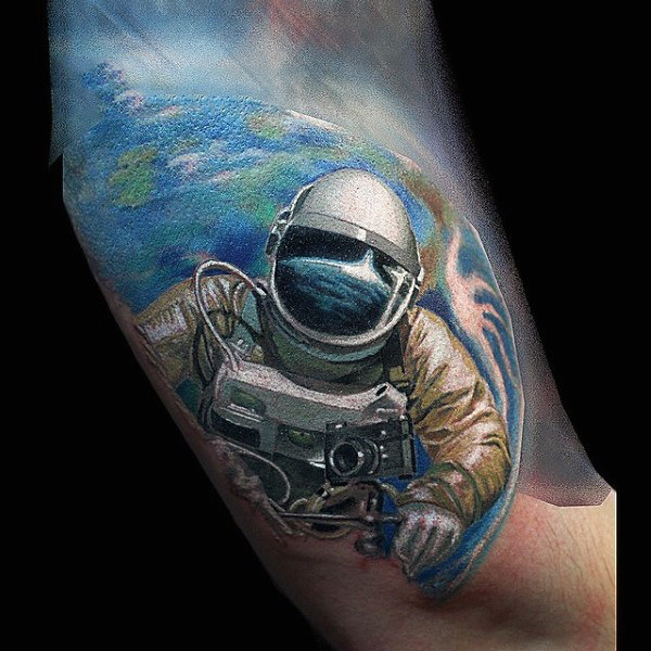 Colored astronaut tattoo on forearm for men