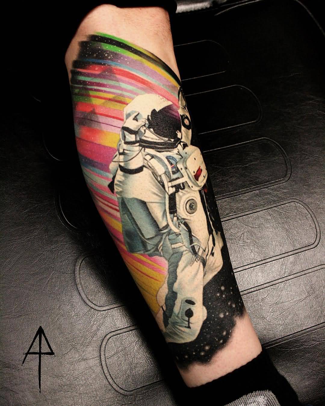 Colored astronaut tattoo with universe on forearm