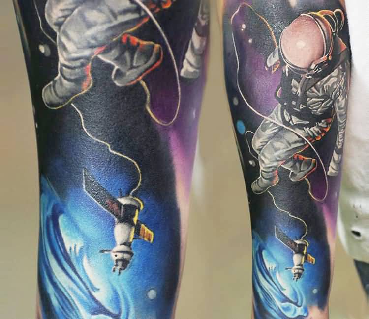 Colored astronaut with satellite tattoo on arm by Levgen