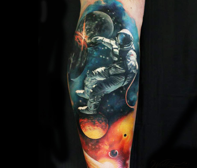 Colored astronaut with universe tattoo on leg by Sergey Shanko