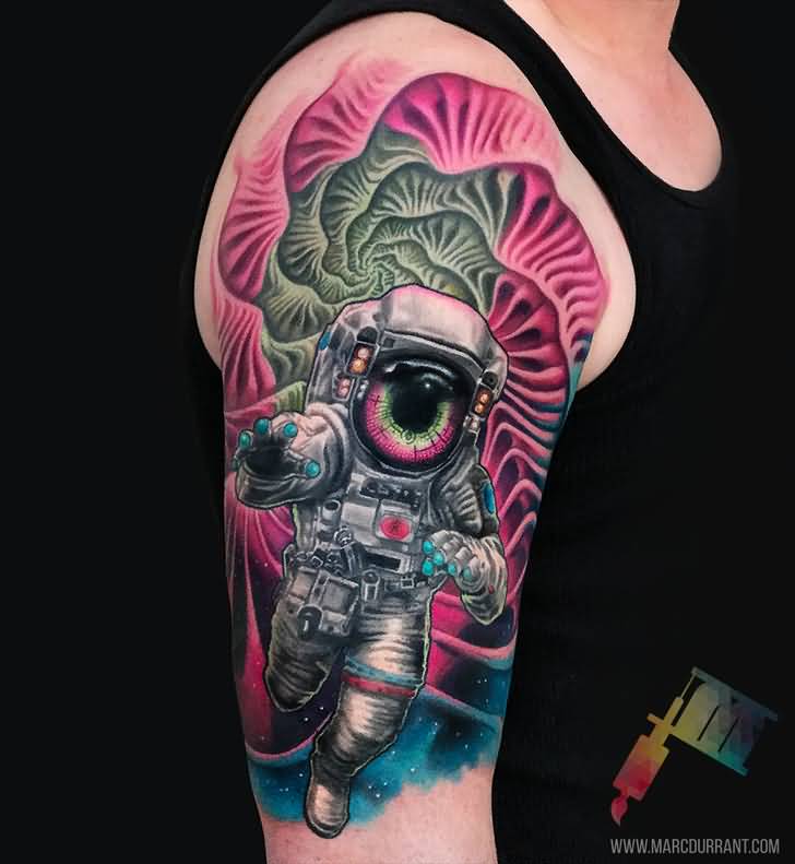 Colorful astronaut with eye tattoo on upper arm