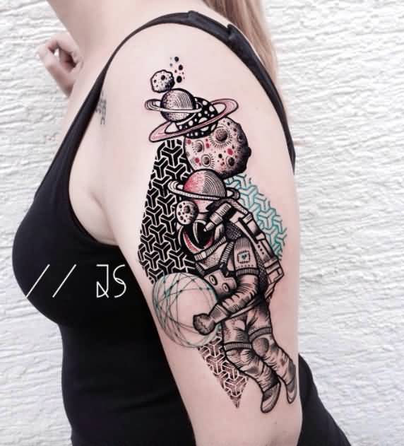 Grey astronaut with planets tattoo on upper arm for women