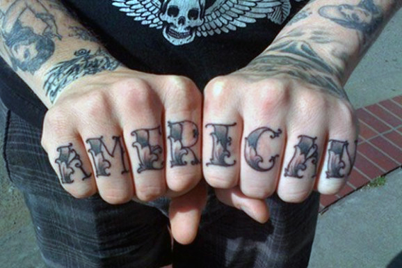 Grey shaded American wording knuckle tattoo