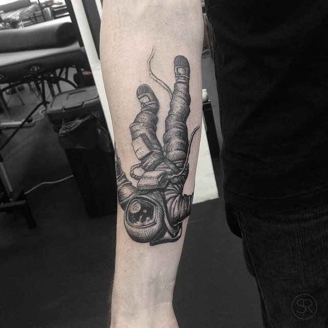 Grey shaded falling astronaut tattoo on arm by Sven Rayen