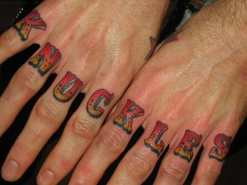 Red and yellow knuckles wording knuckle tattoo