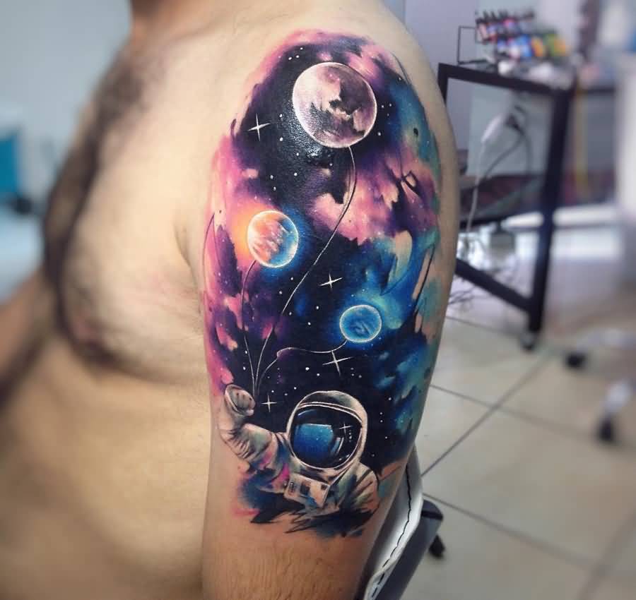 Watercolor astronaut with universe tattoo on arm for men