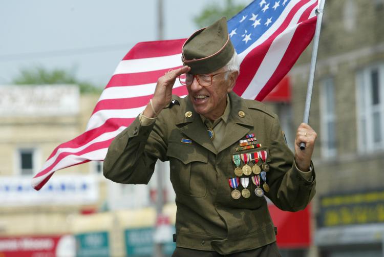 old veteran with us flag on Veterans Day