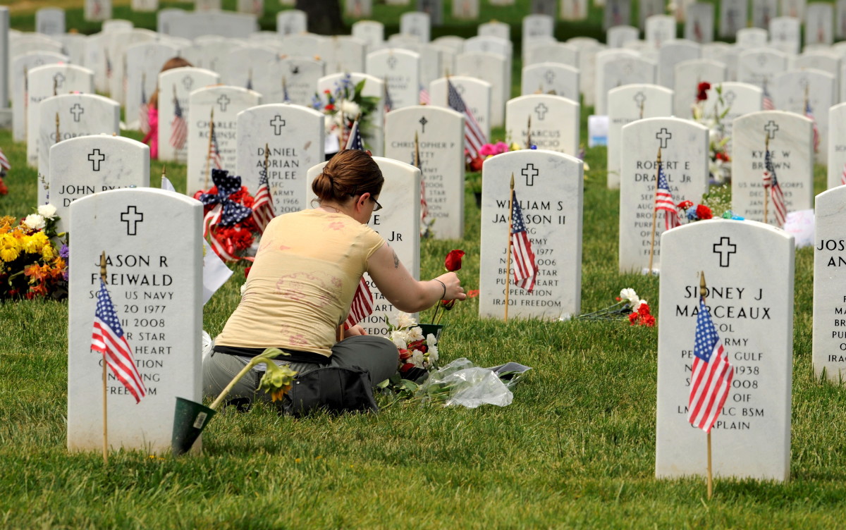 A Woman Pays Respect To Fallen Veterans At Arlington National Cemetery During Memorial Day