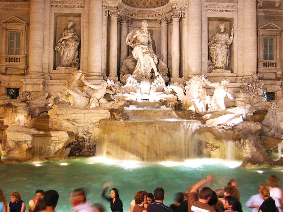 sculptures of Trevi Fountain lit up with night light