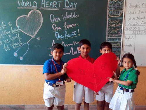 World Heart Day celebration in school kids with paper heart picture